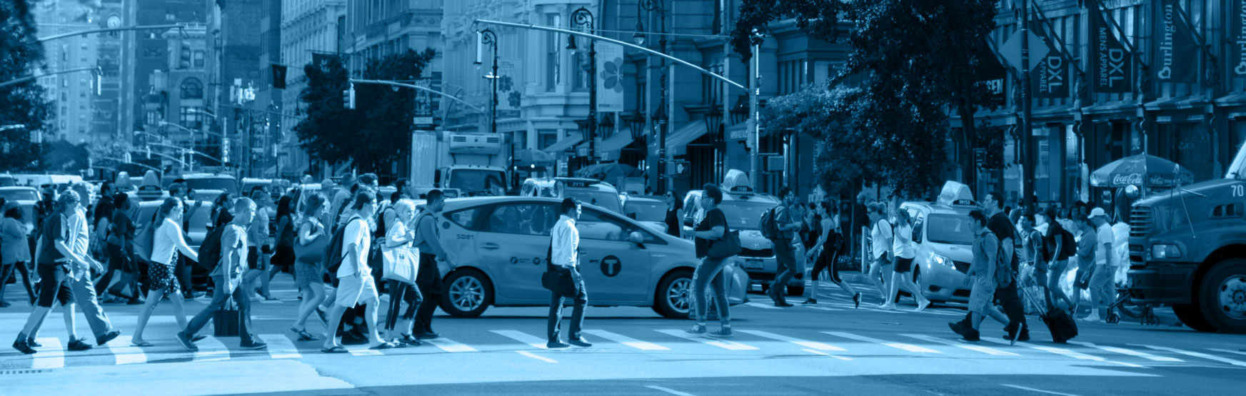 New Yorkers cross 6th avenue at 23rd street.